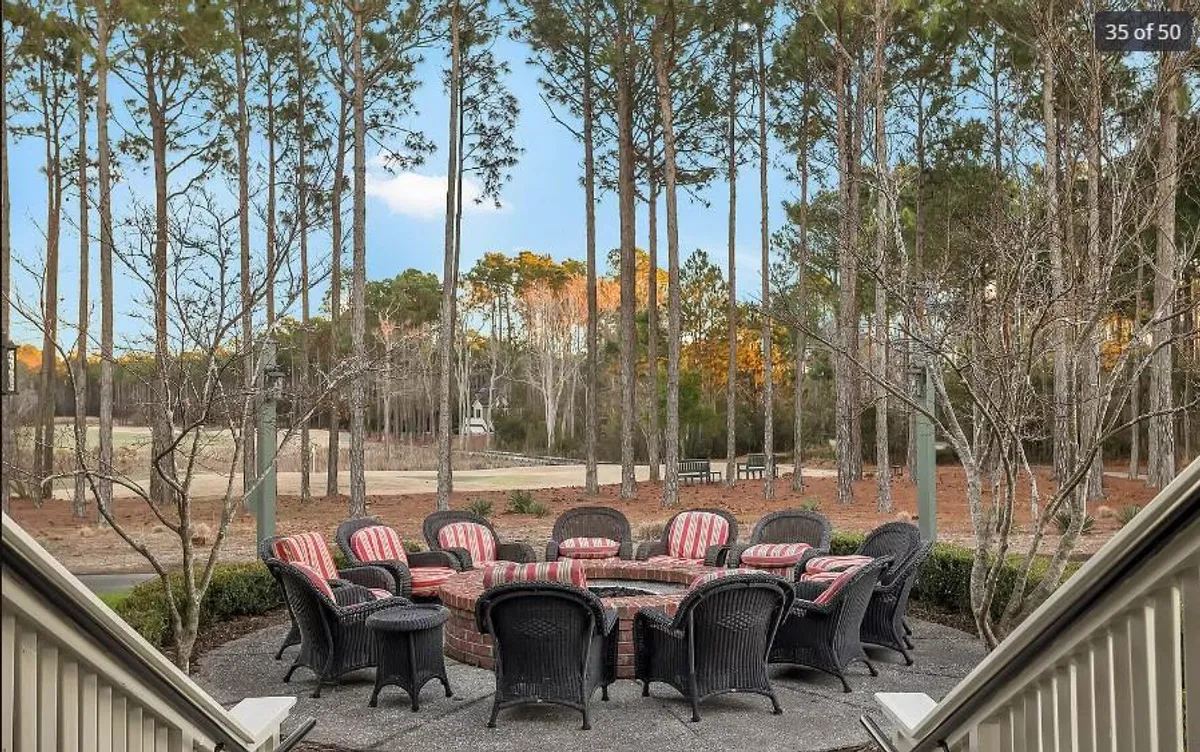 An outdoor fire pit surrounded by seating and tall pine trees, creating a welcoming area for gatherings, social events, or relaxing after enjoying local festivals. The communal setup encourages interaction and shared experiences.